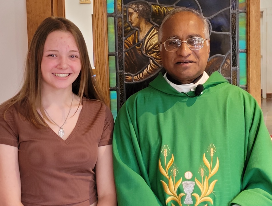 Pastor Fr. John Kizhakedan with a recent confirmand